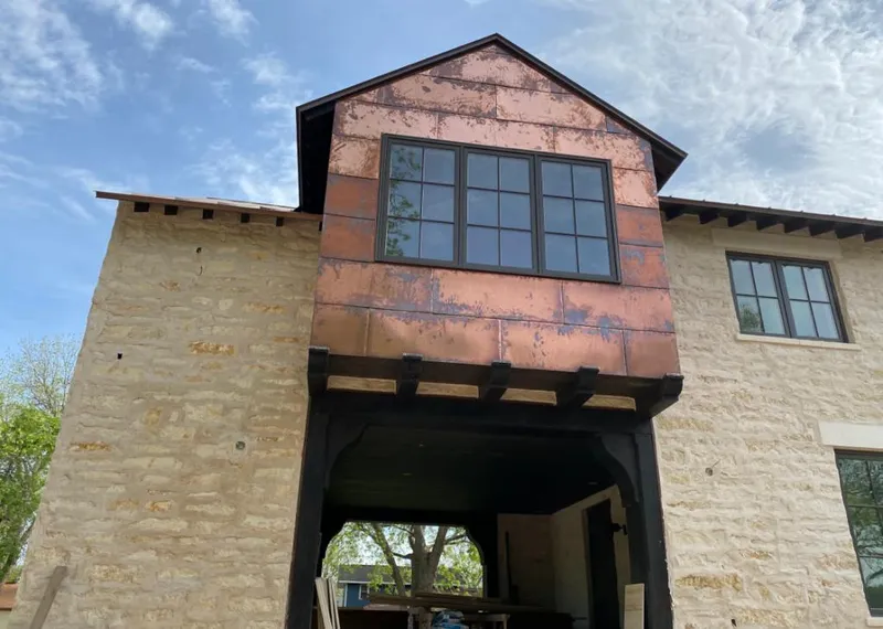 Copper metal panel facade on a stone building for Skylight Installation in Sparks