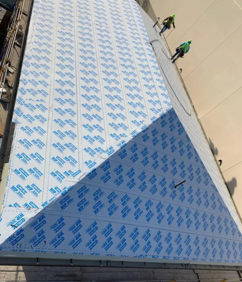 Professional roofers installing underlayment on a metal roof in Sparks